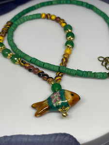 Strand Necklace with mixed material, fish shaped pendant