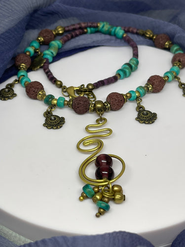 Strand Necklace with mixed materials and spiral pendant